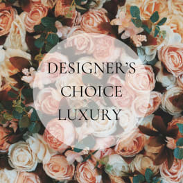 Peach and white roses with greenery and the words "Designer’s Choice Luxury"