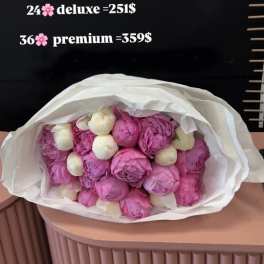 Bouquet of pink and white peonies wrapped in white paper