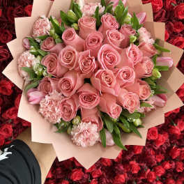 Pink rose bouquet with carnations and tulips wrapped in blush paper