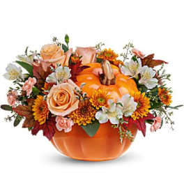 Pumpkin-shaped orange vase with roses and autumn flowers