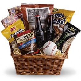 Basket of snacks with two beer bottles and a baseball