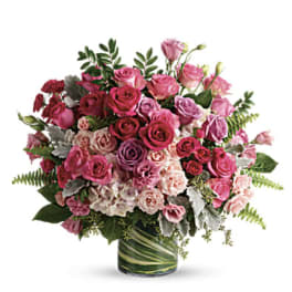 Pink and purple rose bouquet in a glass vase