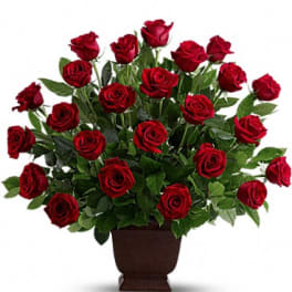 Bouquet of red roses in a brown urn-style vase