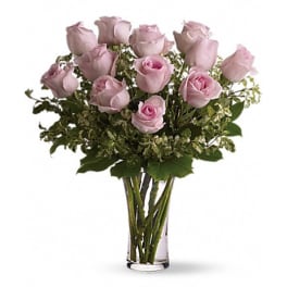 Pink roses arranged in a clear glass vase