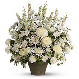 White floral arrangement in a brown vase