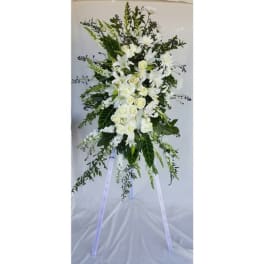 Tall white floral standing spray on a tripod easel