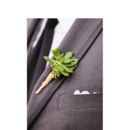 Green succulent boutonniere pinned to a gray suit jacket