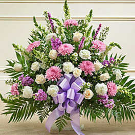 Large pink and white floral spray with a lavender ribbon bow