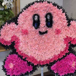 Pink floral character arrangement with a smiling face and black outline