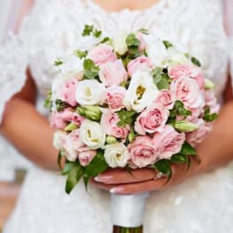 Bride holding a bouquet of pink and white roses