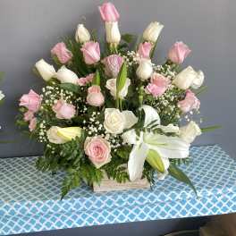 Pink and white roses with lilies in a wooden box arrangement