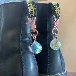 Pair of black platform boots with dangling crystal charms