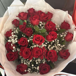 Bouquet of red roses with white baby's breath in white wrapping