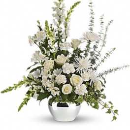 White floral arrangement in a silver vase with tall stems
