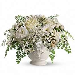 White rose and calla lily arrangement in a decorative urn