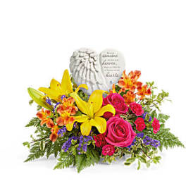 Bright mixed flower arrangement with a memorial angel stone