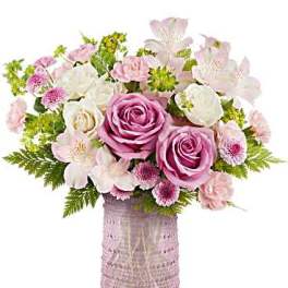 Pink and white mixed flower arrangement in a textured vase