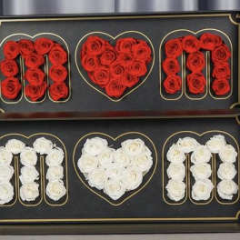 Two framed rose displays spelling MOM with a heart in the center.