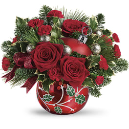 Red roses and carnations arranged in a red ornament vase