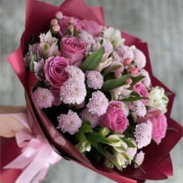 Pink rose and chrysanthemum bouquet wrapped in magenta paper
