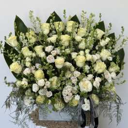 Large bouquet of cream roses and white spray roses with greenery