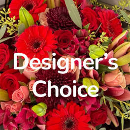 Bouquet of red gerbera daisies, roses, and pink blooms