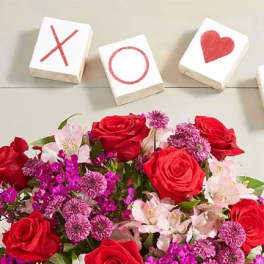 Red and pink flower bouquet beside tic-tac-toe blocks