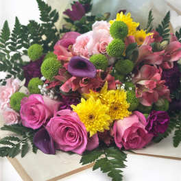 Bouquet of pink roses, yellow chrysanthemums, and purple calla lilies