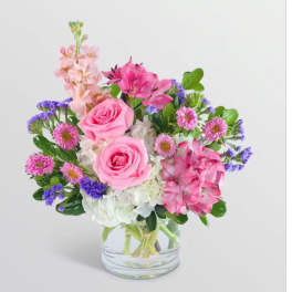 Pink and purple mixed bouquet in a clear glass vase