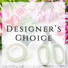 Designer’s Choice text over a floral background with pink tulips and pale blossoms