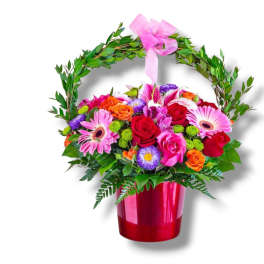 Mixed bouquet in a red vase with a pink ribbon handle