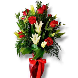 Red roses and white lilies in a red vase with a ribbon