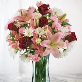Bouquet of pink and red flowers in a clear glass vase