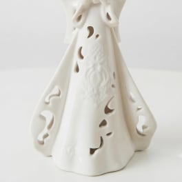 White ceramic angel figurine with cutout details