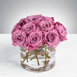 Pink roses arranged in a clear glass vase