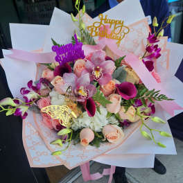 Pink and peach bouquet with orchids, roses, and calla lilies