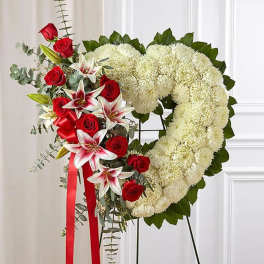 Heart-shaped floral wreath with red roses, white mums, and lilies