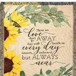 Sunflower-themed decorative blanket with a quote in the center
