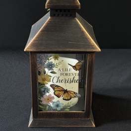 Decorative lantern with a memorial candle and butterfly floral print