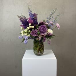 Purple and lavender bouquet in a clear glass vase