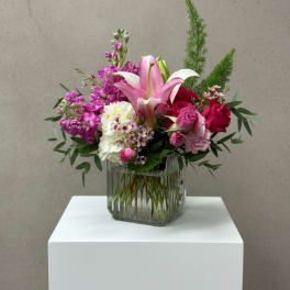 Pink and white floral arrangement in a glass vase