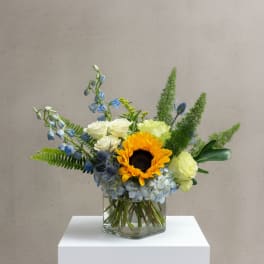 Mixed bouquet with a sunflower in a glass vase