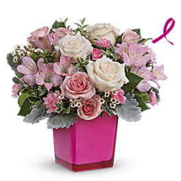 Pink and white rose bouquet in a magenta vase with a ribbon