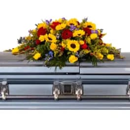 Colorful flower spray arranged on a casket