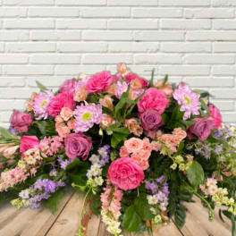 Large bouquet of pink and purple roses with small pastel flowers