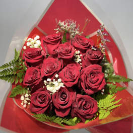 Bouquet of red roses with white filler flowers and fern leaves