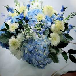 Blue hydrangea bouquet with white roses and pale daisies