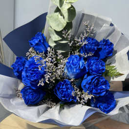 Bouquet of vivid blue roses with white filler and eucalyptus