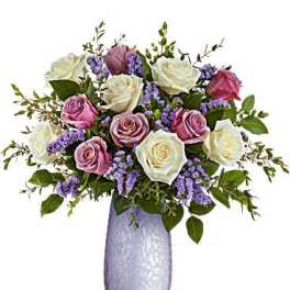 Bouquet of pink and white roses in a lavender vase