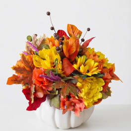 Autumn floral arrangement in a white pumpkin vase